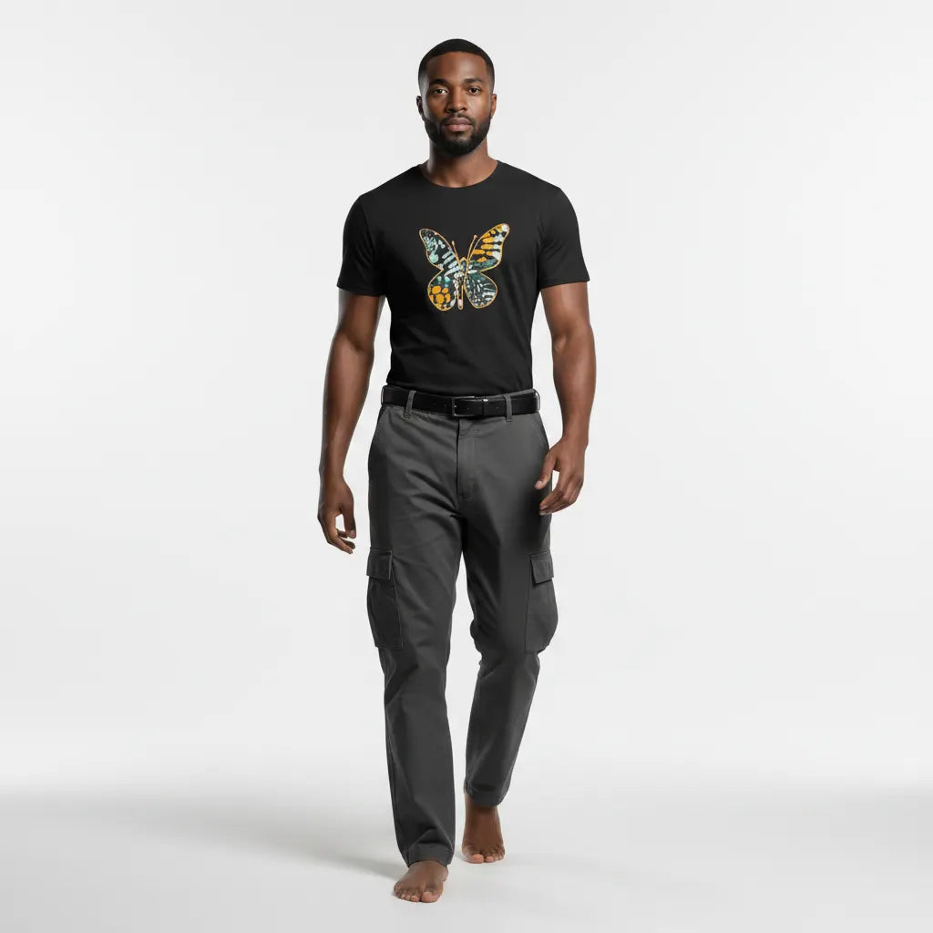 Man wearing a black t-shirt with a colorful butterfly design and gray cargo pants on a white background